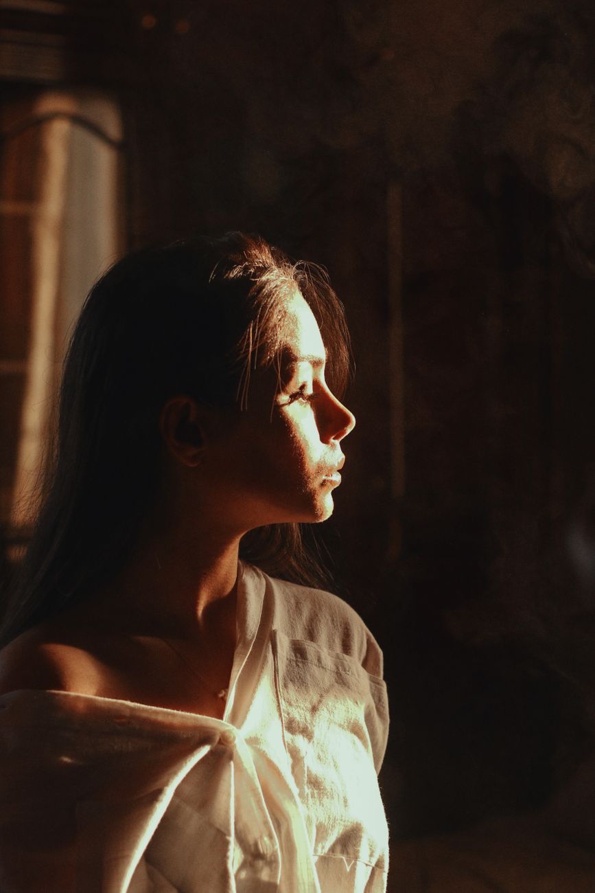 A person sitting quietly in warm light